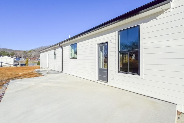 view of side of property with a patio