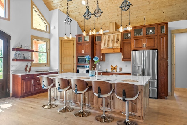 kitchen featuring pendant lighting, glass insert cabinets, an island with sink, wooden ceiling, and black appliances