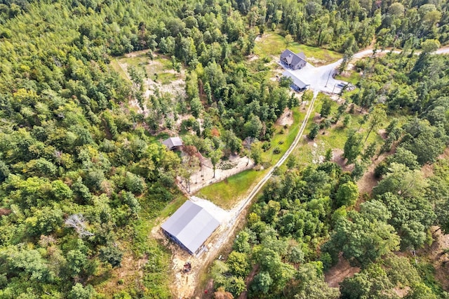 birds eye view of property with a forest view