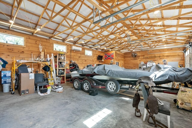 garage featuring wood walls and a wall unit AC