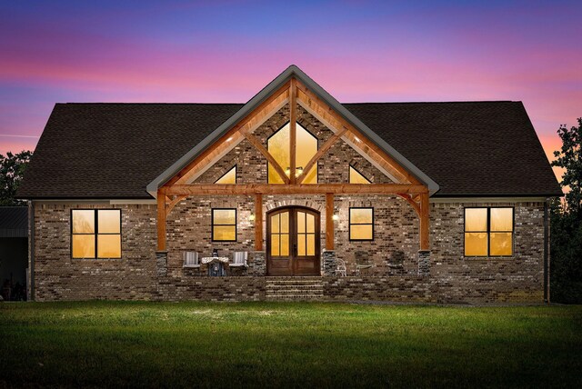 view of front facade featuring a front lawn and brick siding