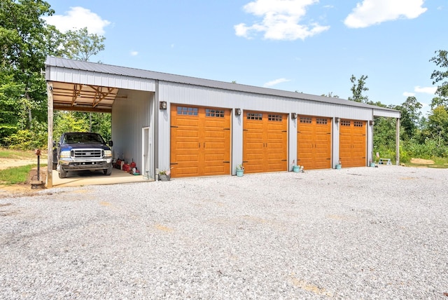 garage with gravel driveway