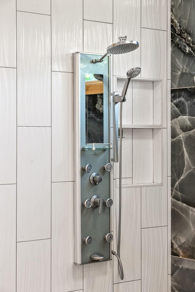 interior details featuring tiled shower