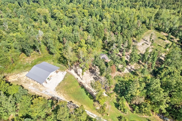 bird's eye view with a wooded view