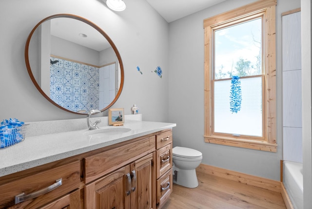 full bath featuring baseboards, vanity, toilet, and wood finished floors