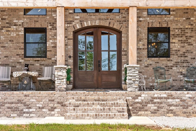 doorway to property with brick siding and french doors