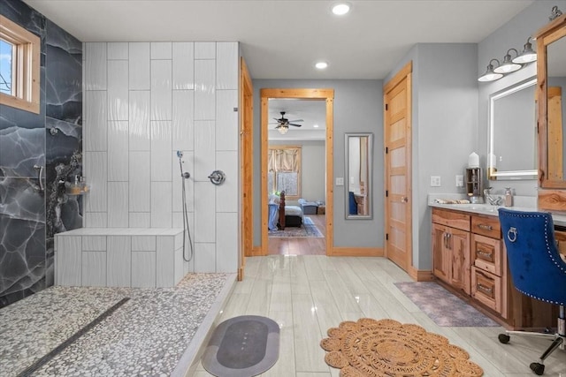 ensuite bathroom featuring a walk in shower, connected bathroom, recessed lighting, wood finished floors, and vanity