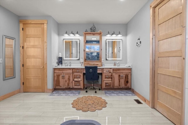 bathroom featuring wood finished floors, vanity, visible vents, and baseboards