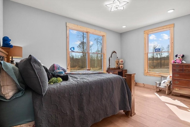 bedroom with recessed lighting, multiple windows, and light wood finished floors