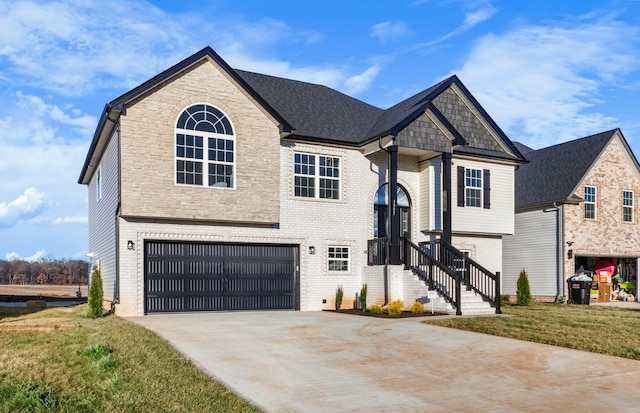 view of front of property featuring a garage, a front yard, concrete driveway, and brick siding