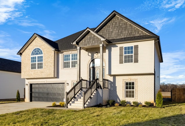 split foyer home featuring a garage, a front yard, brick siding, and driveway