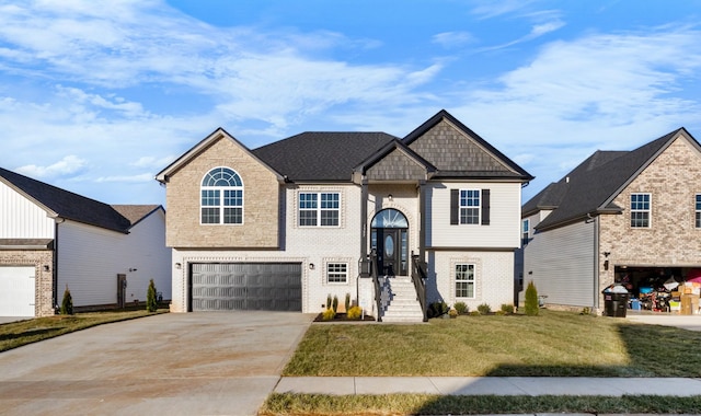 raised ranch featuring driveway, an attached garage, a front lawn, and brick siding