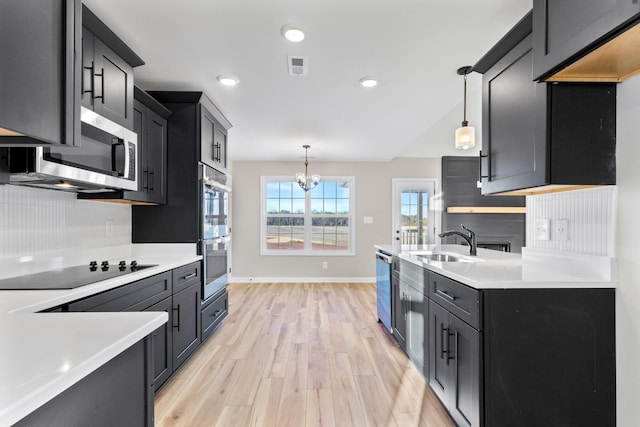 kitchen with visible vents, appliances with stainless steel finishes, light countertops, and a sink