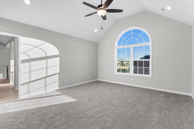 spare room with lofted ceiling, carpet, baseboards, and a ceiling fan