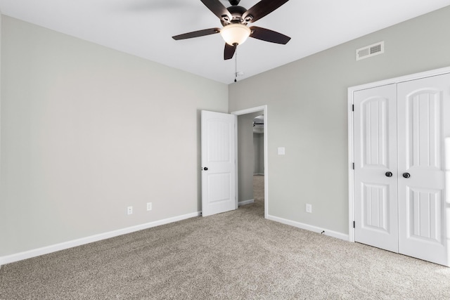 unfurnished bedroom featuring baseboards, visible vents, and carpet flooring