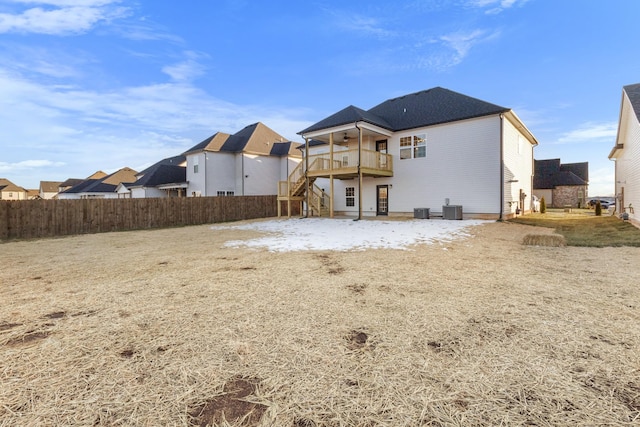 rear view of property featuring a deck, cooling unit, fence, stairway, and a residential view