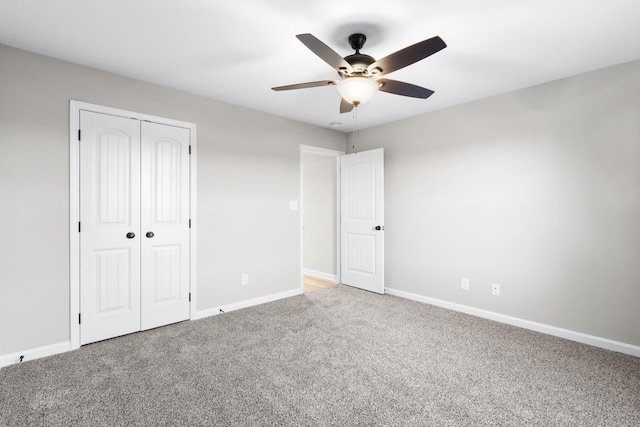 unfurnished bedroom featuring a closet, carpet flooring, ceiling fan, and baseboards