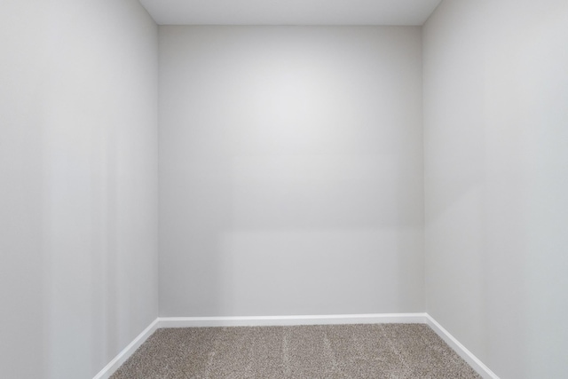 carpeted empty room with baseboards