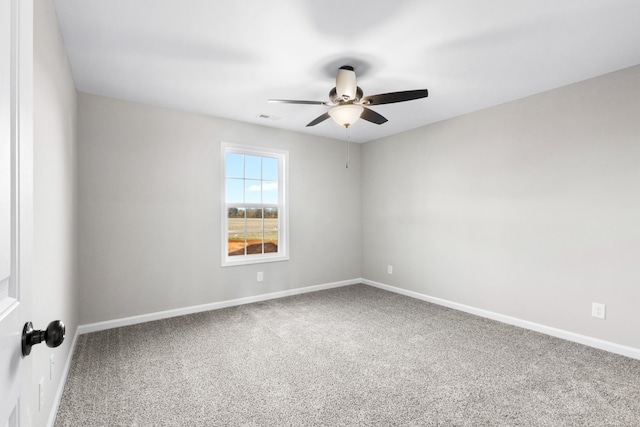 unfurnished room with carpet flooring, ceiling fan, and baseboards