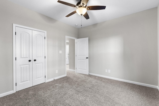 unfurnished bedroom with a closet, carpet flooring, ceiling fan, and baseboards