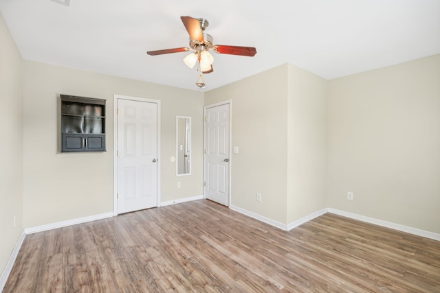 unfurnished bedroom featuring wood-type flooring and ceiling fan