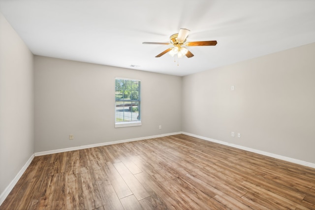 empty room featuring wood-type flooring and ceiling fan