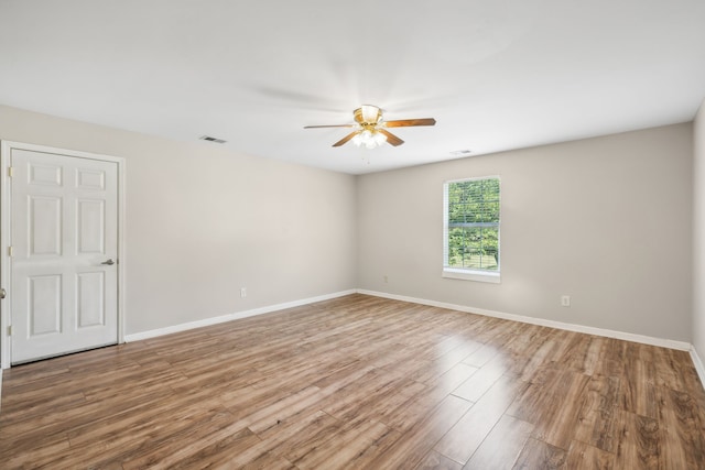 empty room featuring hardwood / wood-style floors and ceiling fan