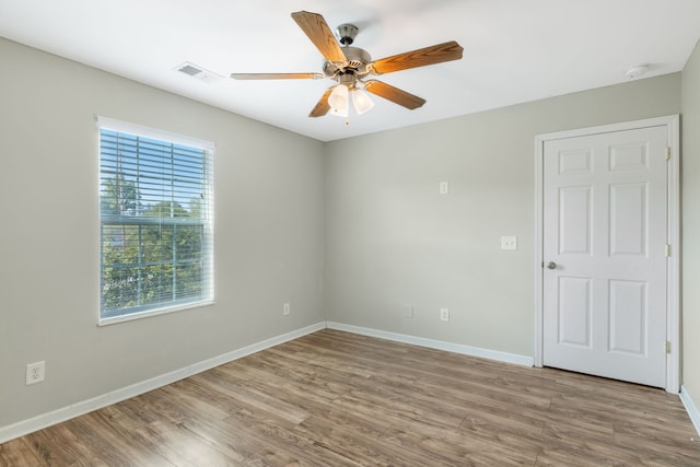 empty room featuring hardwood / wood-style floors and ceiling fan