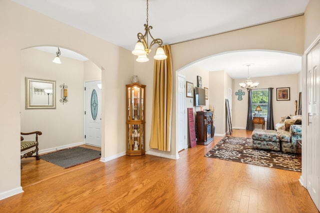 entrance foyer with light wood-type flooring and a chandelier