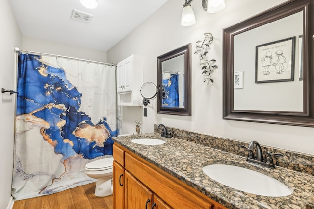 bathroom featuring curtained shower, hardwood / wood-style floors, toilet, and vanity