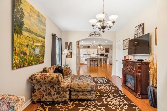 living room with an inviting chandelier and hardwood / wood-style floors