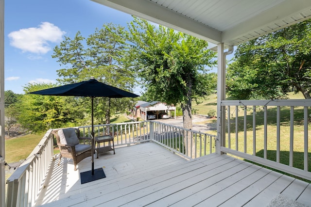 wooden terrace with a yard