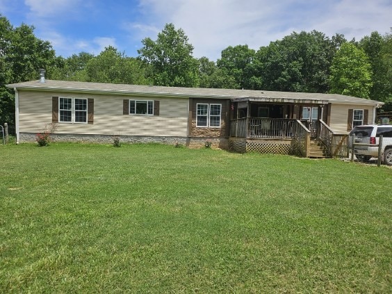 view of front of property with a front lawn and a deck