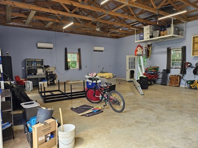 garage featuring ceiling fan and a wall mounted air conditioner