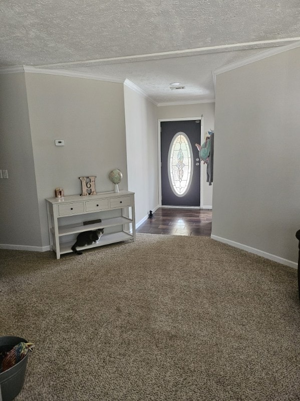 entrance foyer with hardwood / wood-style flooring, a textured ceiling, and ornamental molding