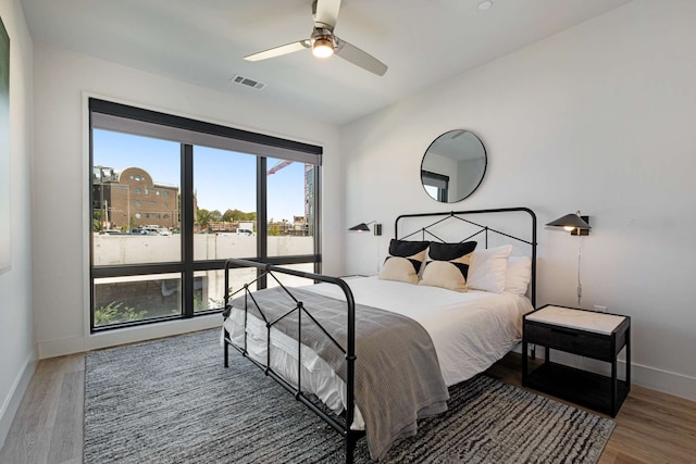 bedroom with dark wood-type flooring and ceiling fan