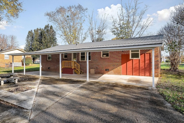 118 Van Buren St, Mcminnville, TN 37110 - back of property with brick siding, a metal roof, driveway, and an attached carport