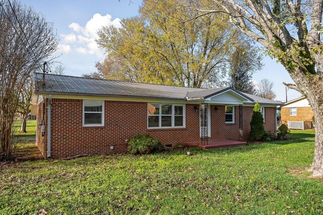 118 Van Buren St, Mcminnville, TN 37110 - view of front of house with a metal roof, brick siding, and a front lawn