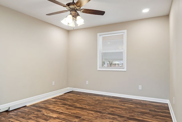 empty room with dark hardwood / wood-style flooring and ceiling fan