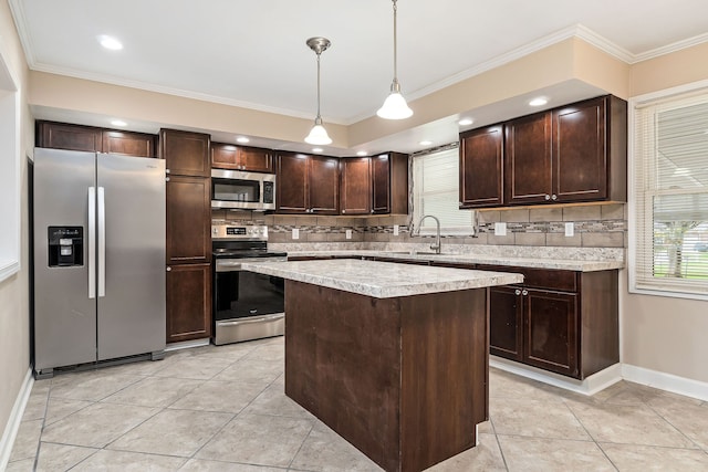 kitchen featuring pendant lighting, backsplash, sink, a kitchen island, and stainless steel appliances