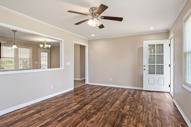 unfurnished room with ceiling fan with notable chandelier, dark hardwood / wood-style flooring, and crown molding