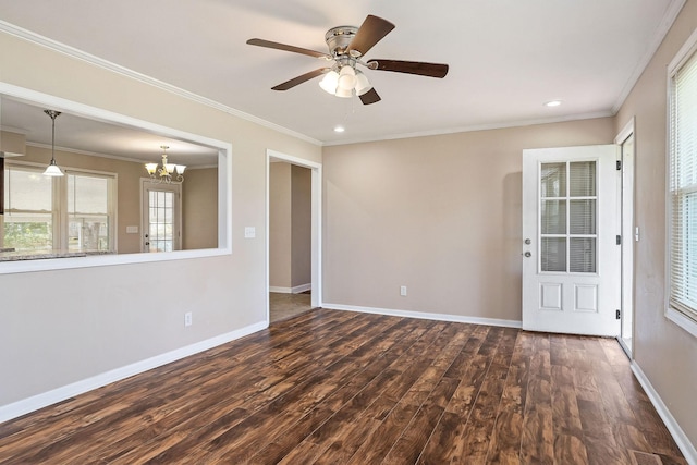 118 Van Buren St, Mcminnville, TN 37110 - spare room with dark wood finished floors, healthy amount of natural light, a chandelier, a ceiling fan, and crown molding