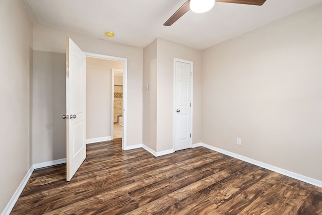 unfurnished bedroom with ceiling fan and dark hardwood / wood-style flooring