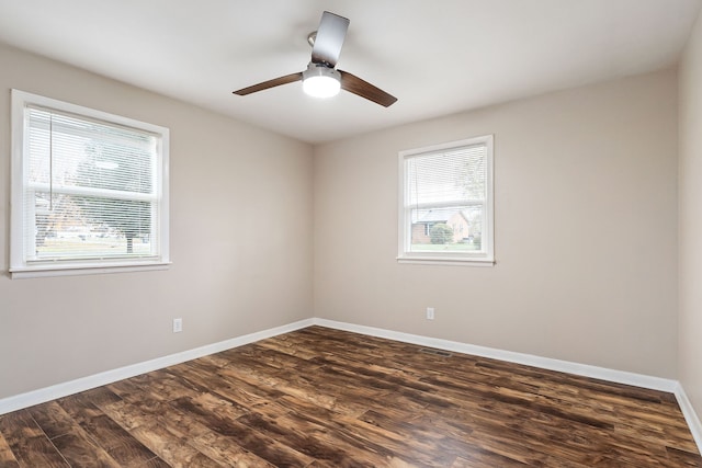 empty room with ceiling fan and dark wood-type flooring