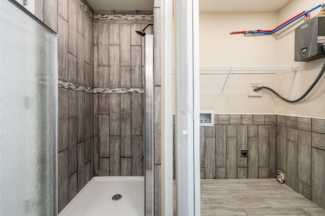 bathroom featuring a shower with shower door