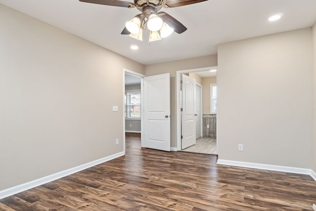 spare room featuring dark hardwood / wood-style floors and ceiling fan