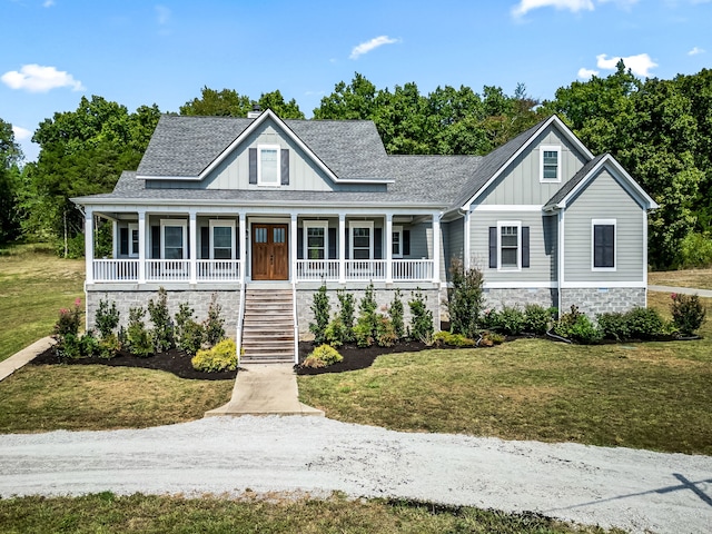 view of front of house with a front yard and covered porch