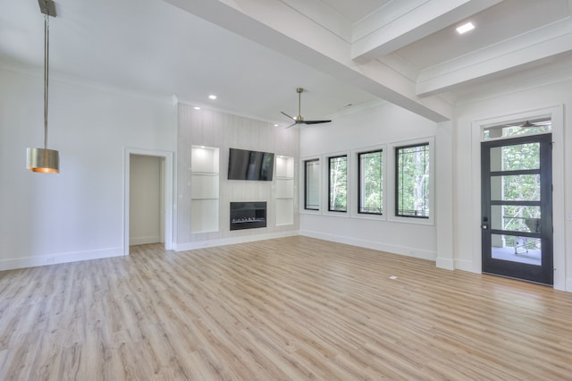 unfurnished living room with light wood-type flooring, a fireplace, beam ceiling, and ceiling fan