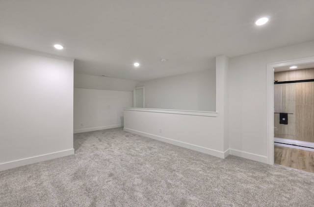 basement featuring light colored carpet