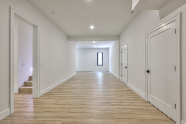 hallway with light hardwood / wood-style floors